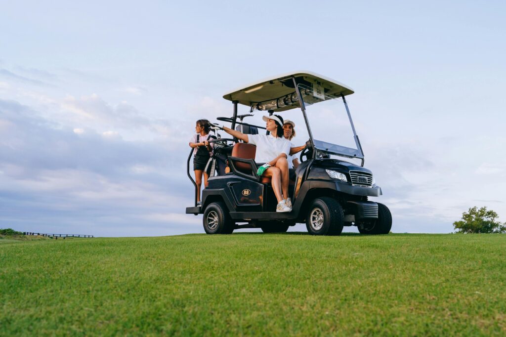 A family enjoys a relaxing golf cart ride on a sunny day at the golf course.